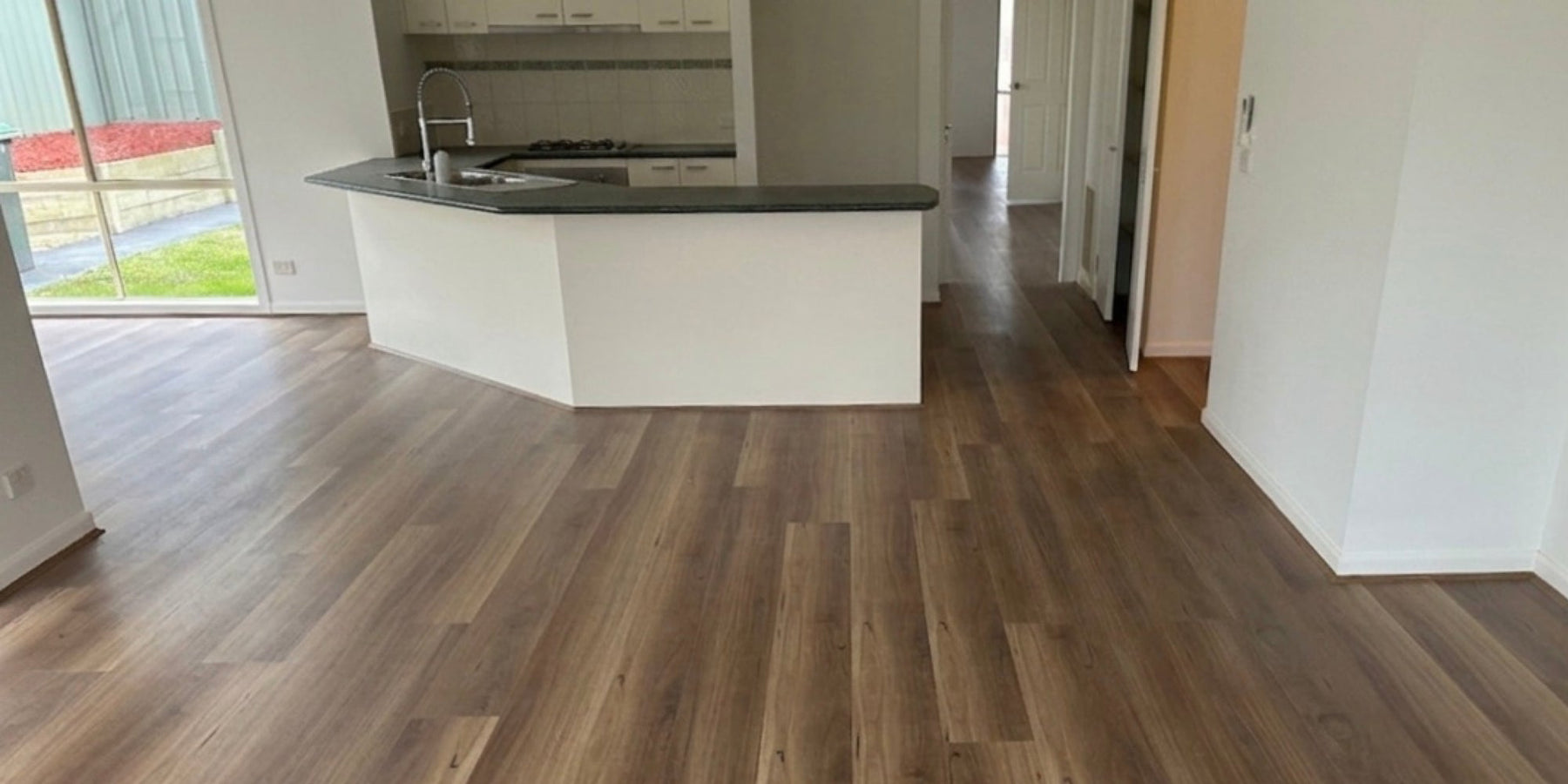 Spotted gum hybrid flooring installed in an open-plan Melbourne home