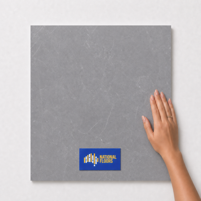 Graphite TM10 600x600 tile with hand scale and National Floors card