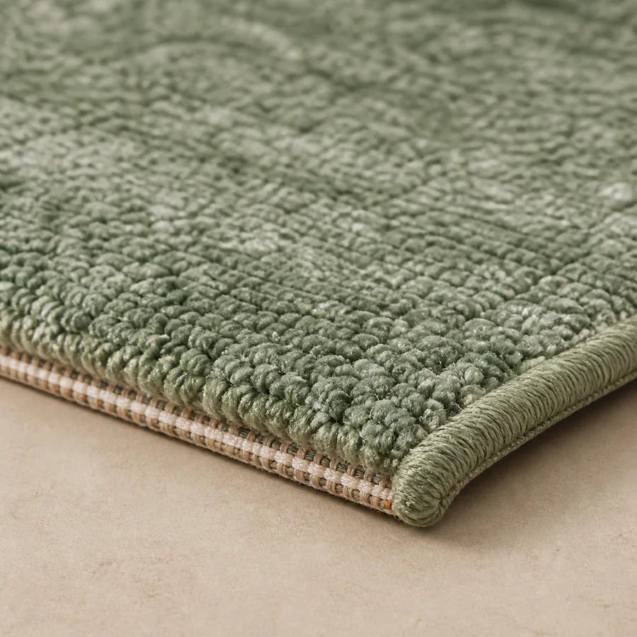 Close up of a tufted rug edge with backing